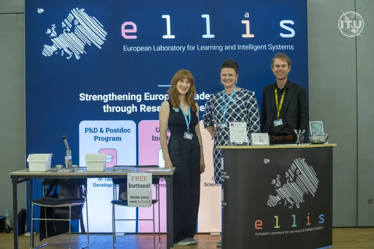 Lena Schadock, Christine Funke and Conrad Philipp standing in front of a backwall with ELLIS printed on it at the AI for Good Global Summit conference 2025