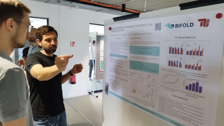 Man gesturing at a poster at ELLIS Unit Berlin