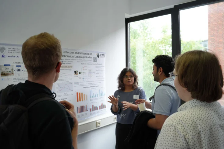 A woman talking in front of a poster at ELLIS Unit Darmstadt