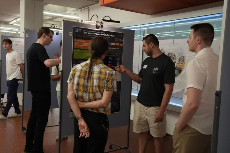 People looking at a poster at ELLIS Institute Tuebingen's poster session in Stuttgart