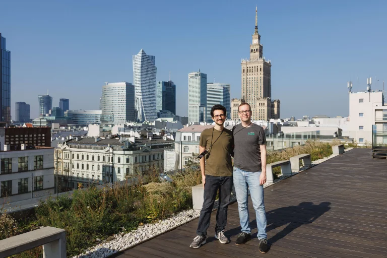 Filippo Caldera & Marcus Ackermann from ELLIS Unit Darmstadt and Zuse School ELIZA in front of the Warsaw skyline