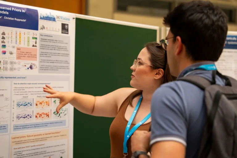 Students looking at a poster at the ELLIS Doctoral Symposium 2026 in Lisbon