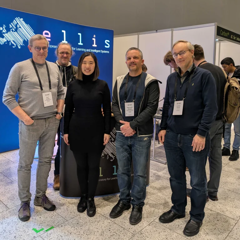 Bernt Schiele, Bernhard Schölkopf, Zhijing Jin 2025 ELLIS PhD Award Winner, Serge Belongie, Andreas Krause, all standing in front of the ELLIS Booth at the UnConference