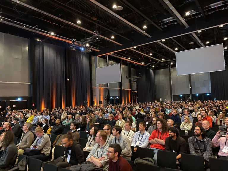 Lots of people sitting in the auditorium at EurIPS