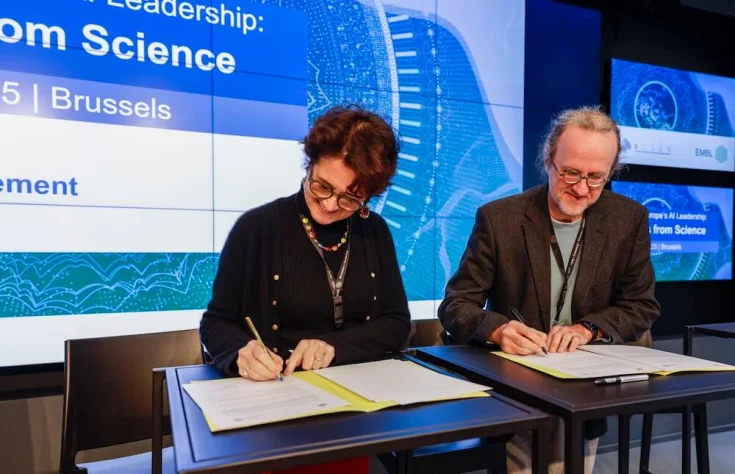 Photo of Edith Heard and Bernhard Schoelkopf signing an MoU on behalf of EMBL and ELLIS in Brussels