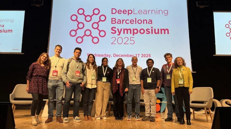 ELLIS Pre-NeurIPS Fest 2025: Unit Barcelona, people standing on a stage in front of a presentation