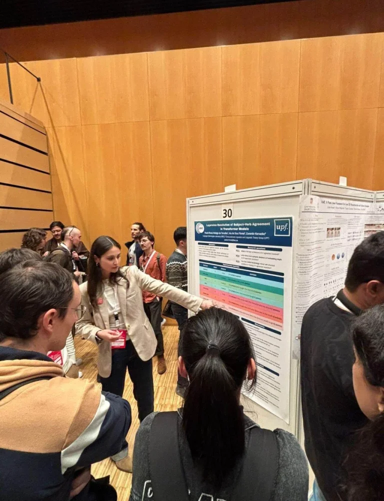 ELLIS Pre-NeurIPS Fest 2025: Unit Barcelona, a woman pointing to a poster
