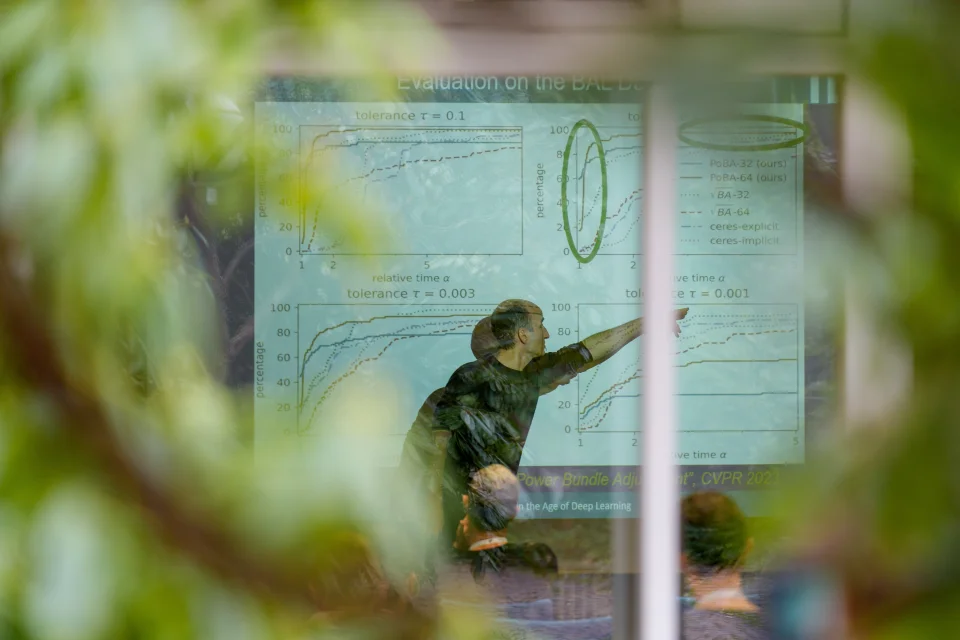 Man pointing at a presentation on a screen