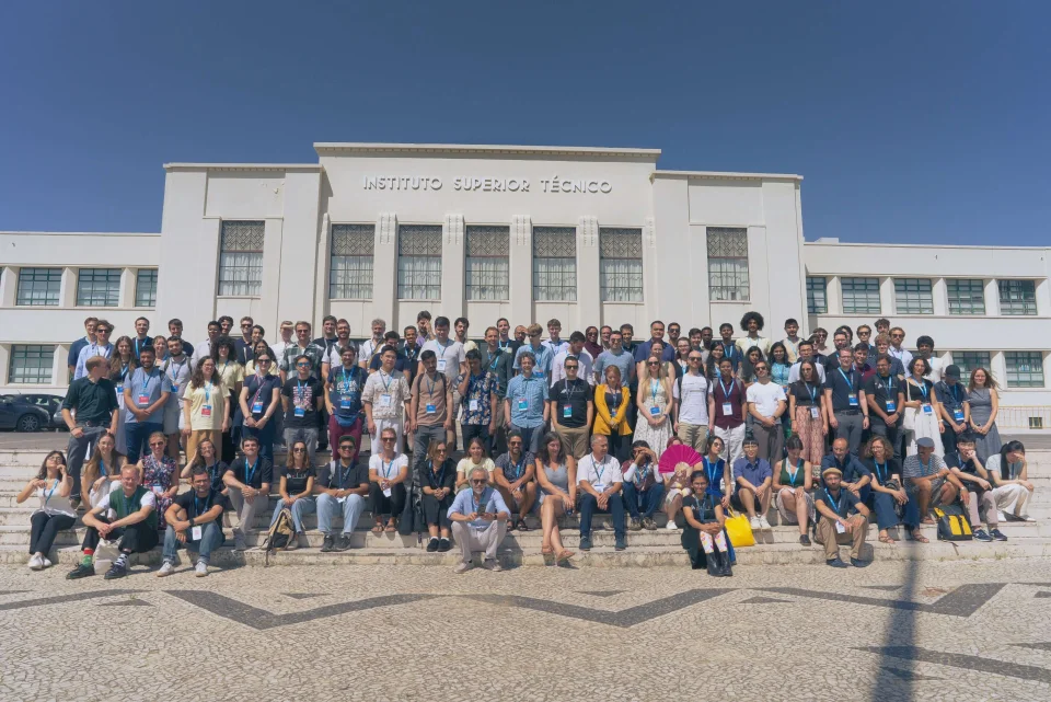 Group photo of lots of ELLIS PhD students in front of the Institute Superior Tecnico Building in Lisbon for the ELLIS Doctoral Symposium