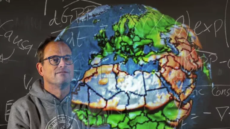 Photo of Markus Reichstein in front of a globe and writing