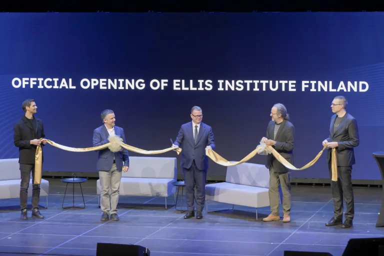 Text Official Opening of ELLIS Institute Finland on a screen behind the following people holding a symbolic yellow ribbon: Peter Sarlin, Serge Belongie, Finnish Prime Minster Petteri Orpo, Bernhard Schölkopf, and Samuel Kaski