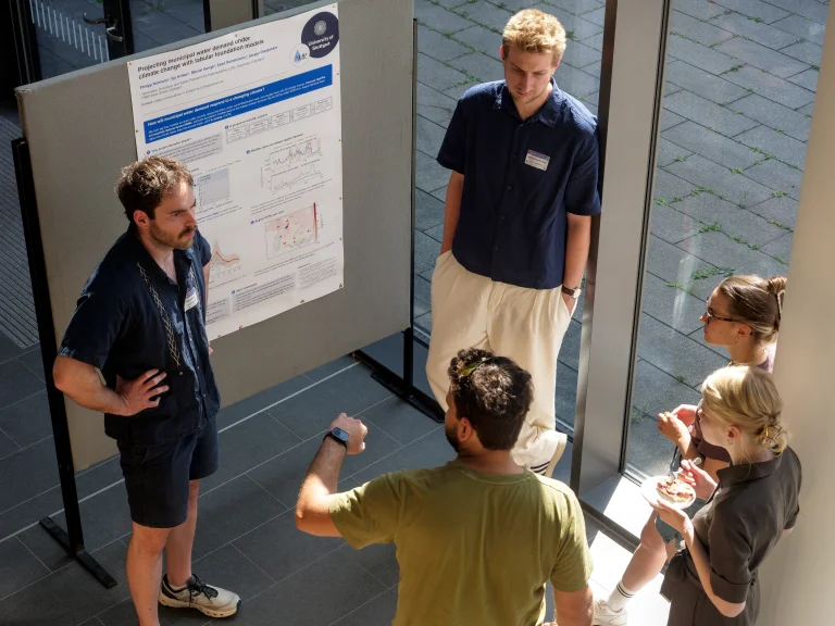 Participants presenting and discussing their research during the poster session.